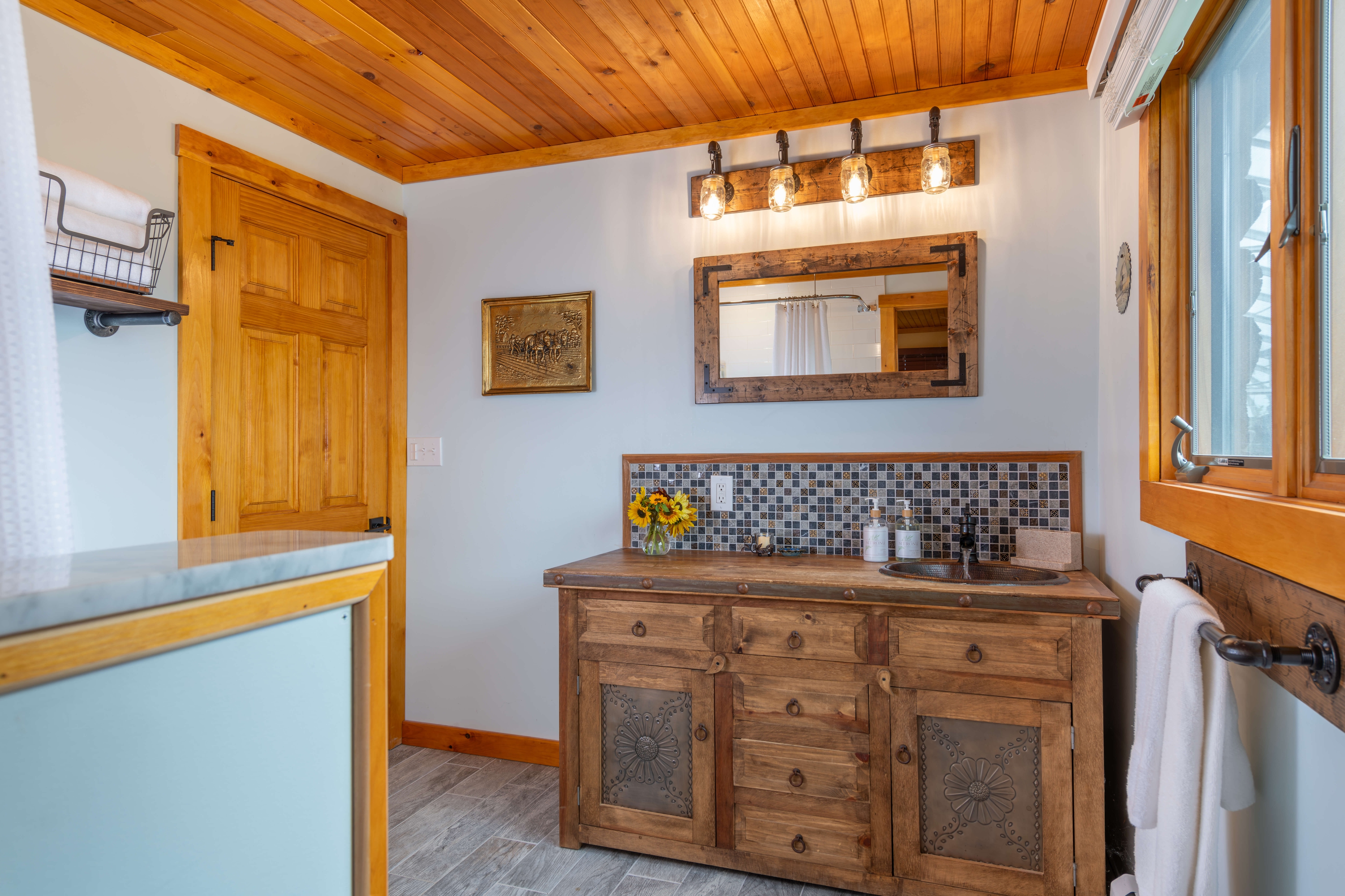 Wooden vanity with decorative tile backsplash