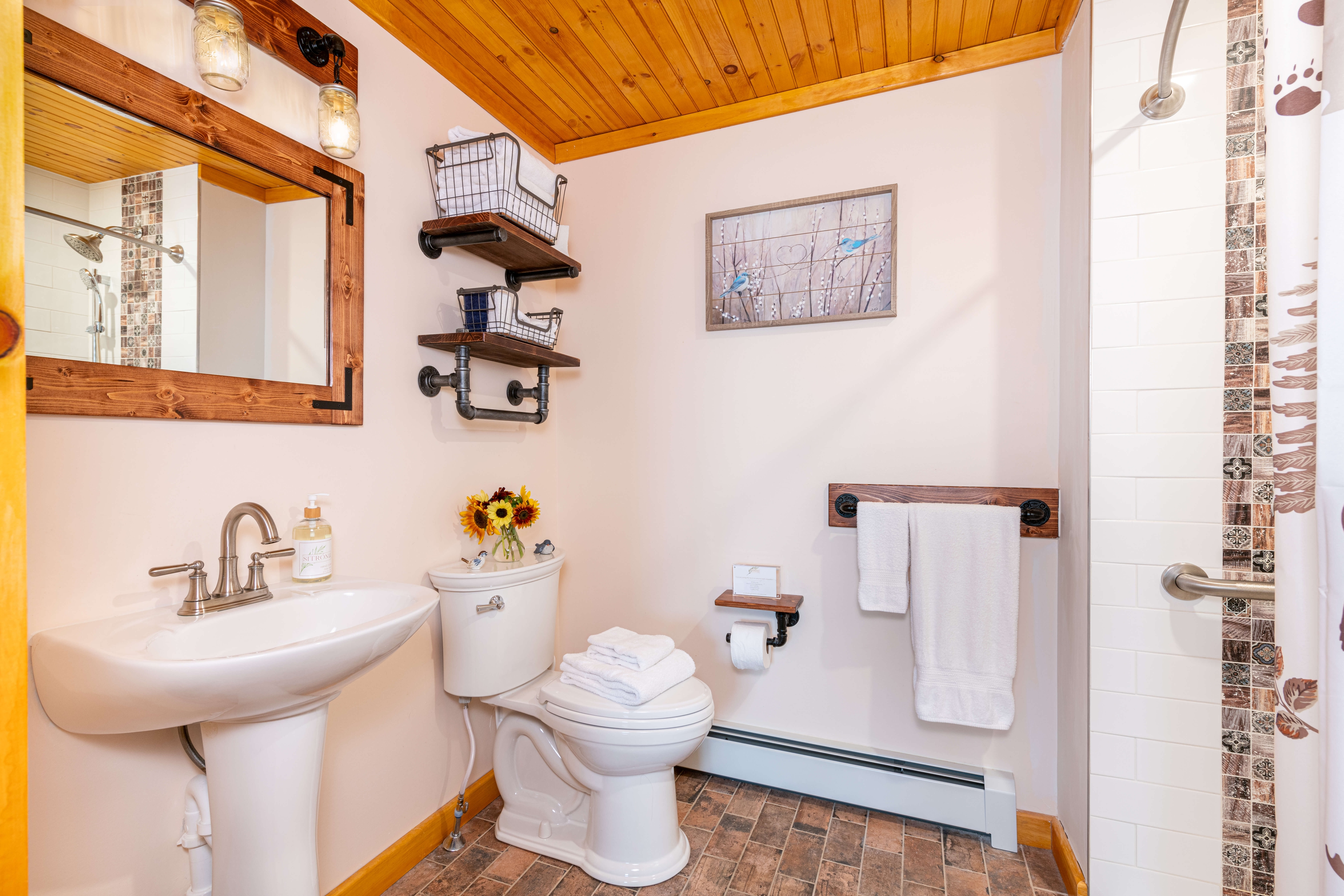 Bathroom with pedestal sink and shelves above the toilet