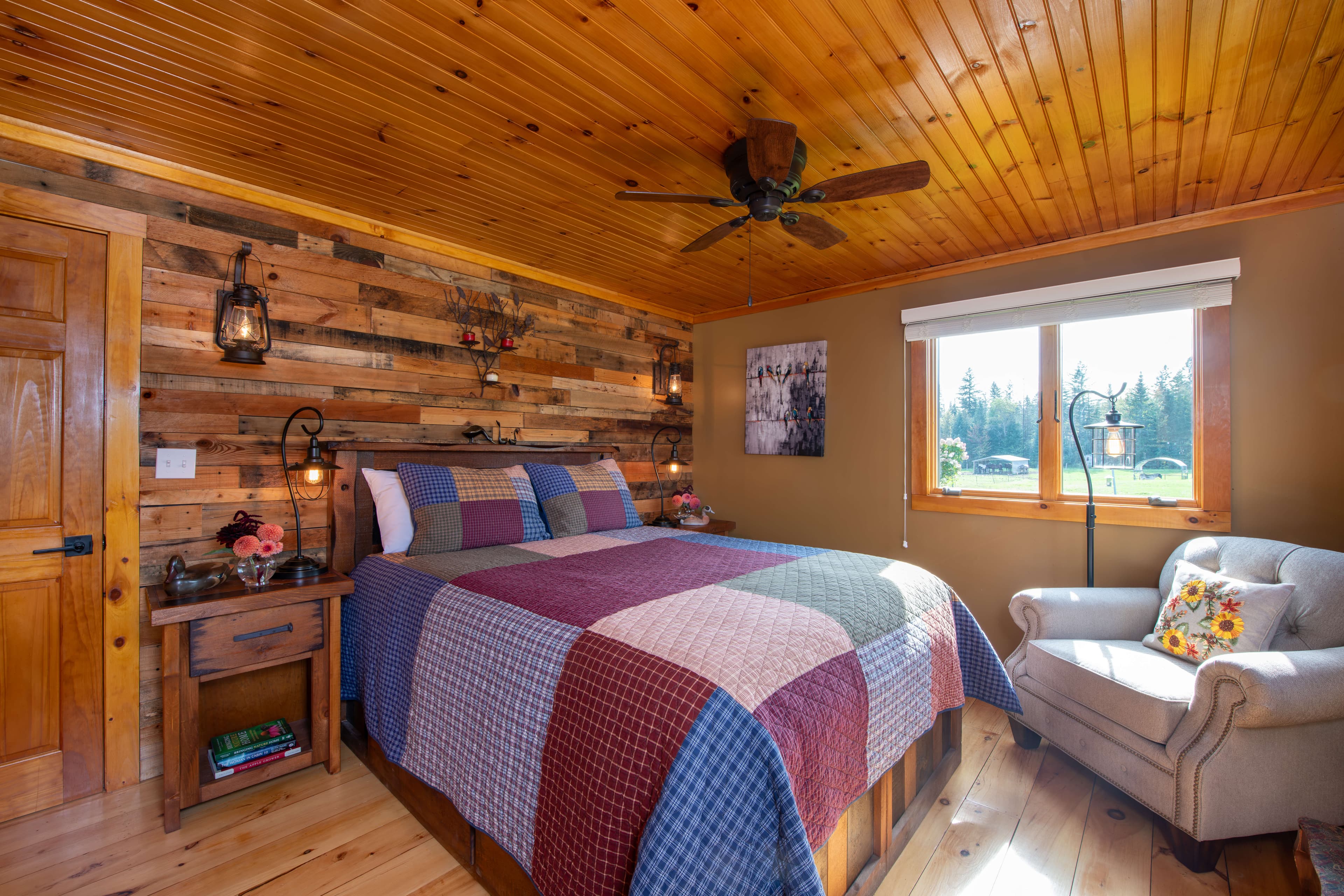 Queen bed with patchwork quilt and comfy upholstered chair