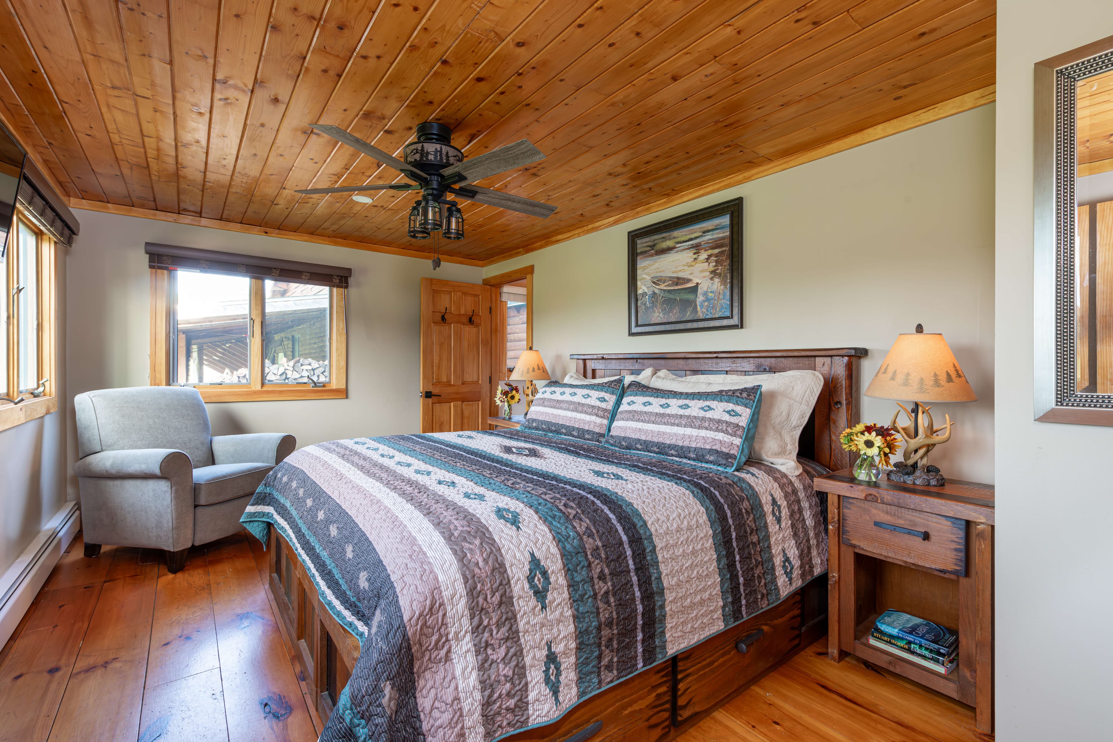 King Bed with geometric quilt and antler lamps on nightstands