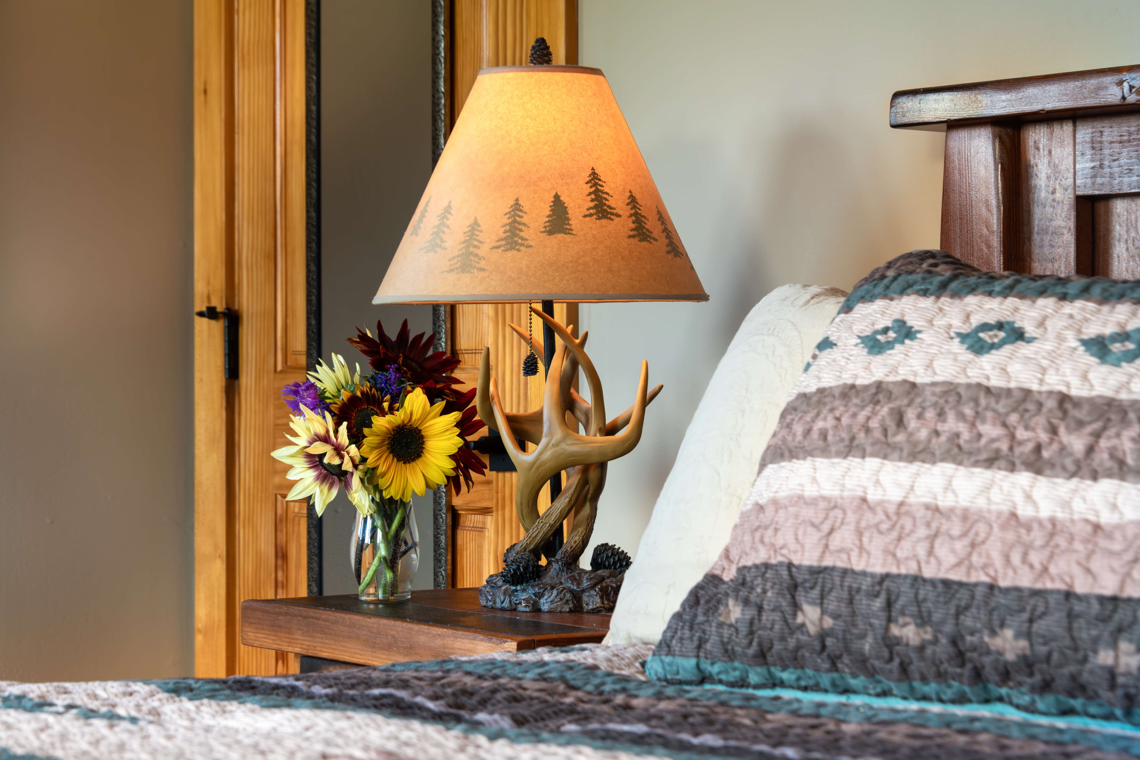 King bed with deer antler lamp on nightstand