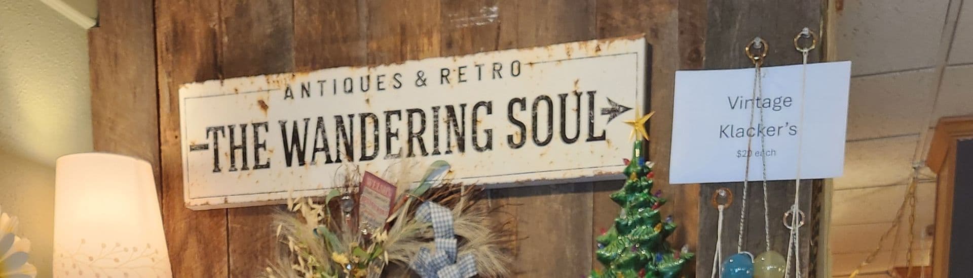 Large sign for an antiques store on a wood pallet wall